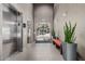 Well-lit hallway featuring elevators, access to the outside, and plants at 17 W Vernon Ave # 121, Phoenix, AZ 85003