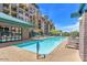 Exterior view of a clean pool surrounded by lounge chairs in a well maintained community at 17 W Vernon Ave # 121, Phoenix, AZ 85003