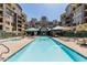 Exterior view of a community pool with clear water, lounge chairs and surrounding apartment complex at 17 W Vernon Ave # 121, Phoenix, AZ 85003