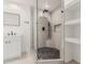 Modern walk-in shower with beautiful stone and black river rock flooring, plus built in shower bench and shelves at 17 W Vernon Ave # 121, Phoenix, AZ 85003