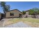 View of the backyard with a block wall and patio area next to the house at 17953 N Lettere Cir, Maricopa, AZ 85138