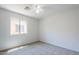 Bedroom features neutral carpet, and a window overlooking the outdoors at 17953 N Lettere Cir, Maricopa, AZ 85138
