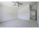 Bright bedroom features a modern ceiling fan and soft carpeting at 17953 N Lettere Cir, Maricopa, AZ 85138