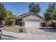 Inviting home featuring a two-car garage, xeriscaped yard, and a covered porch at 17953 N Lettere Cir, Maricopa, AZ 85138
