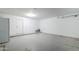 Clean garage with white walls, a bright light fixture and an exterior door at 17953 N Lettere Cir, Maricopa, AZ 85138