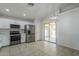 Bright kitchen with stainless appliances, white cabinets, and an open layout to the backyard at 17953 N Lettere Cir, Maricopa, AZ 85138