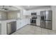 Well-lit kitchen featuring stainless steel appliances, white cabinets, and an open layout at 17953 N Lettere Cir, Maricopa, AZ 85138