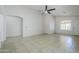 Open living room with neutral colors, tile flooring, and lots of natural light at 17953 N Lettere Cir, Maricopa, AZ 85138