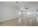Spacious living room featuring neutral tones, a ceiling fan, and tile flooring throughout at 17953 N Lettere Cir, Maricopa, AZ 85138