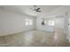 Open-concept living room featuring tile floors leading into the kitchen, fostering a spacious feel at 17953 N Lettere Cir, Maricopa, AZ 85138