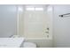 Shower and tub combination with white tiled walls at 17953 N Lettere Cir, Maricopa, AZ 85138