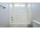 Shower and tub combination with white tiled walls at 17953 N Lettere Cir, Maricopa, AZ 85138