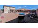 Spacious backyard offering seating, a shade umbrella, and a splash pool at 18586 N Lariat Rd, Maricopa, AZ 85138