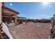 Spacious backyard features a gravel landscape, covered patio, and outdoor entertaining area at 18586 N Lariat Rd, Maricopa, AZ 85138