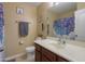 Well-lit bathroom featuring a vanity, mirror, and patterned shower curtain at 18586 N Lariat Rd, Maricopa, AZ 85138