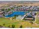 Aerial view of neighborhood lake with sports courts, playground and picnic areas at 18586 N Lariat Rd, Maricopa, AZ 85138