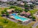 Aerial view of the community pool area with lounge chairs, splash pad, and shade structures at 18586 N Lariat Rd, Maricopa, AZ 85138