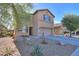 Two-story home showcasing desert landscaping and a well-manicured front yard at 18586 N Lariat Rd, Maricopa, AZ 85138