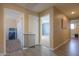 Hallway with wood-style floors leads to bedrooms, bathroom, and storage at 18586 N Lariat Rd, Maricopa, AZ 85138