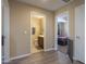 Hallway with wood-style floors leads to a bathroom and bedrooms at 18586 N Lariat Rd, Maricopa, AZ 85138