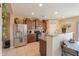 Well-lit kitchen equipped with stainless steel appliances, and wood cabinets at 18586 N Lariat Rd, Maricopa, AZ 85138
