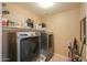 Laundry room equipped with modern washer, dryer, and ample storage space at 18586 N Lariat Rd, Maricopa, AZ 85138