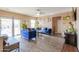 Spacious living room featuring wood-look flooring, sliding glass doors, and neutral-colored walls at 18586 N Lariat Rd, Maricopa, AZ 85138