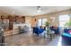 Inviting living room featuring wood-look flooring, modern furniture, and an open concept floorplan at 18586 N Lariat Rd, Maricopa, AZ 85138