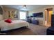 View of main bedroom with a ceiling fan, tan walls, and carpet floor at 18586 N Lariat Rd, Maricopa, AZ 85138