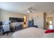 Spacious main bedroom featuring neutral decor, two TVs, and a ceiling fan at 18586 N Lariat Rd, Maricopa, AZ 85138