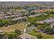 Aerial view of the neighborhood showcasing tree-lined streets and community lake at 18586 N Lariat Rd, Maricopa, AZ 85138