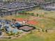 Aerial view of community sports complex featuring baseball fields, tennis courts, and parking at 18586 N Lariat Rd, Maricopa, AZ 85138