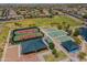 Aerial view of community tennis and basketball courts with nearby covered picnic areas at 18586 N Lariat Rd, Maricopa, AZ 85138