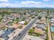 This aerial shot features the home, a long street view, and other homes with pools at 1902 E 8Th St, Mesa, AZ 85203