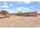 Spacious backyard with desert landscaping featuring green grass near the house and a patio at 1902 E 8Th St, Mesa, AZ 85203
