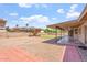 Backyard with gravel, a small lawn, and a covered patio with ceiling fans at 1902 E 8Th St, Mesa, AZ 85203
