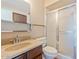 Bathroom features a shower with sliding glass doors, tan countertop, and dark wood cabinets at 1902 E 8Th St, Mesa, AZ 85203