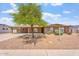 Charming single-story home featuring desert landscaping, mature shade tree, and arched window details at 1902 E 8Th St, Mesa, AZ 85203