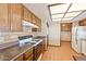 Kitchen featuring wood cabinets, countertop, tile floor and modern appliances at 1902 E 8Th St, Mesa, AZ 85203