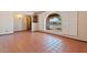 Bright, airy living room with terracotta tile flooring and a unique arch window at 1902 E 8Th St, Mesa, AZ 85203
