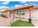 Inviting front entrance with hanging flower baskets, a brick walkway, and a well-maintained garden at 1985 W Anderson Ave, Phoenix, AZ 85023