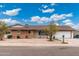 Charming single-story home featuring a brick facade, manicured landscaping, and an attached two car garage at 1985 W Anderson Ave, Phoenix, AZ 85023