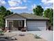 Charming home featuring stone accents, a neutral color palette, and a convenient two-car garage at 2011 E Bucking Bronco Dr, San Tan Valley, AZ 85140