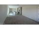 Spacious living area featuring plush carpeting and a modern kitchen with an island at 2011 E Bucking Bronco Dr, San Tan Valley, AZ 85140