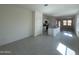 Open-concept living area with tile flooring leading to a kitchen and bright natural light at 2011 E Bucking Bronco Dr, San Tan Valley, AZ 85140