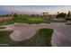 An aerial view of the golf course features expansive greens and a meticulously maintained sand trap at 22208 N San Ramon Dr, Sun City West, AZ 85375