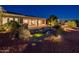 Backyard with patio, water feature, and mature landscaping at night at 22208 N San Ramon Dr, Sun City West, AZ 85375