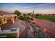 Picturesque backyard with a beautiful water feature, putting green view and a covered patio with an outdoor kitchen at 22208 N San Ramon Dr, Sun City West, AZ 85375