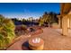 Beautiful backyard featuring a fire pit, water feature, desert landscaping, outdoor kitchen and community golf course at 22208 N San Ramon Dr, Sun City West, AZ 85375