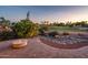 A well manicured backyard includes outdoor fire feature, water feature and scenic golf course view at 22208 N San Ramon Dr, Sun City West, AZ 85375